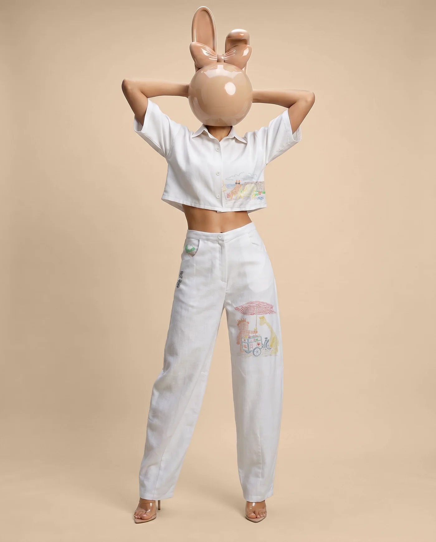 White cropped Not Toys shirt styled with white pants